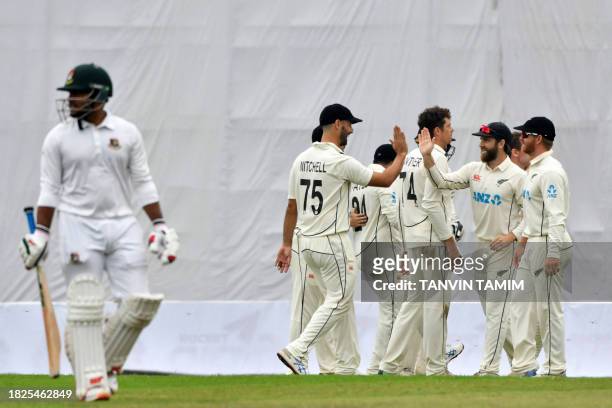 New Zealand's cricketers celebrate after the dismissal of Bangladesh's Zakir Hasan during the first day of the second Test cricket match between...