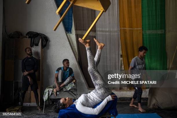 Circus artists train before the daily free class with kids from the neighbourhood at the Fekat Circus in Addis Ababa on December 4, 2023. Nested in a...