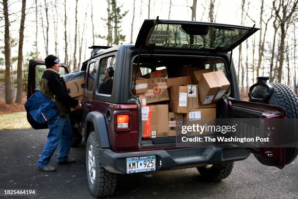 Rural mail carrier Dennis Nelson delivering Amazon packages to a home in remote northern Minnesota on November 25, 2023. The Bemidji Post Office has...