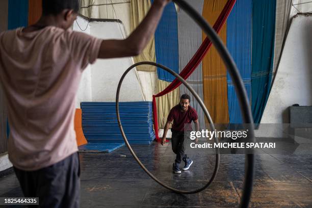 Circus artists train before the daily free class with kids from the neighbourhood at the Fekat Circus in Addis Ababa on November 29, 2023. Nested in...