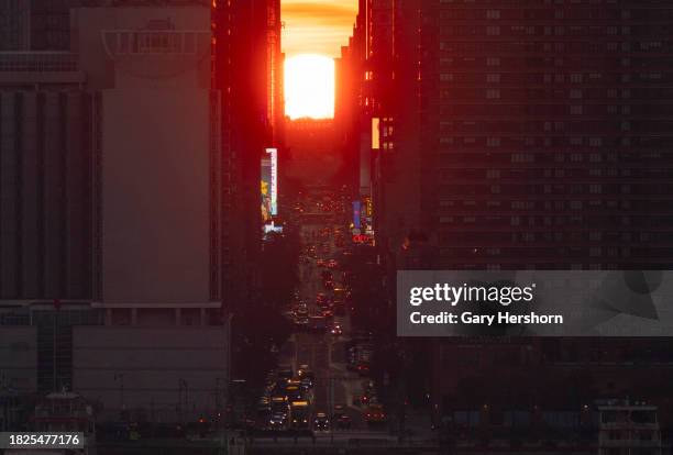 The sun rises over 42nd street during a sunrise Manhattanhenge in New York City on December 1 as seen from Weehawken, New Jersey.