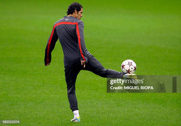 Atletico Madrid's Argentinian coach Diego Simeone controls a ball during a training session at the Dragao stadium in Porto on September 30, 2013 on...