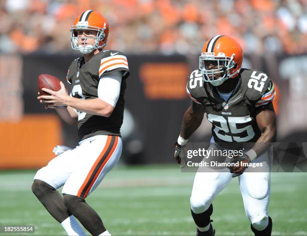 Quarterback Brandon Weeden of the Cleveland Browns drops back to pass with running back Chris Ogbonnaya setting up in pass protection beside him...