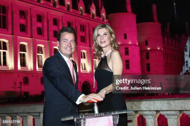 Michele Laroque and Henk Van Der Mark attend the 'Octobre Rose' party hosted by Estee Lauder at La Conciergerie on September 30, 2013 in Paris,...