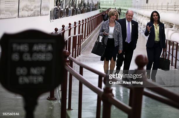 Members of U.S. House of Representatives walk in the Cannon Tunnel on their way for a procedural vote at the House Chamber September 30, 2013 on...