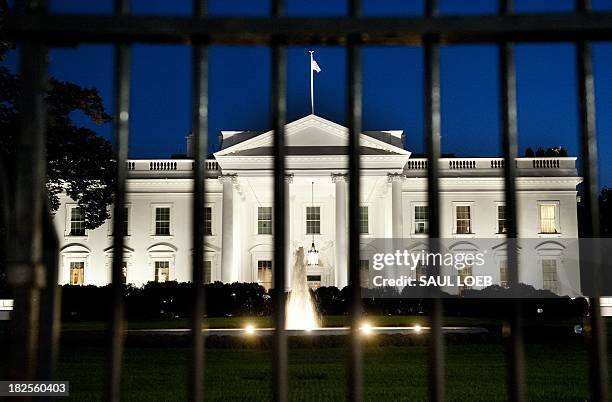 The White House is seen at dusk on the eve of a possible government shutdown as Congress battles out the budget in Washington, DC, September 30,...