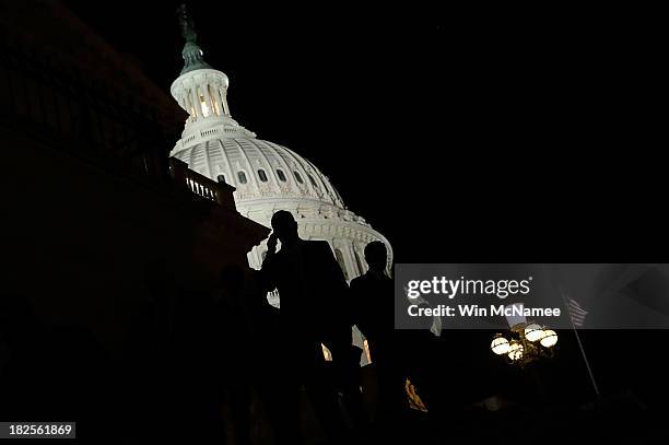 Members of the House of Representatives leave the U.S. Capitol after passing a continuing resolution to fund the U.S. Government that would also...