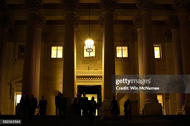 Members of the House of Representatives leave the U.S. Capitol after passing a continuing resolution to fund the U.S. Government that would also...