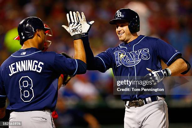 Evan Longoria celebrates with Desmond Jennings of the Tampa Bay Rays after hitting a two-run homerun in the third inning against the Texas Rangers in...