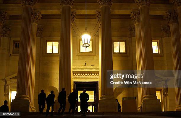 Members of the House of Representatives enter the U.S. Capitol before passing a continuing resolution to fund the U.S. Government that would also...