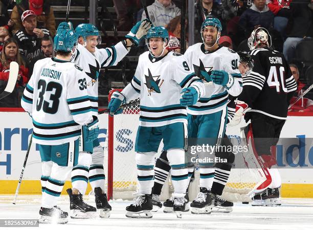 Jacob MacDonald of the San Jose Sharks is congratulated by teammates Calen Addison and Justin Bailey during the second period against the New Jersey...