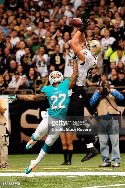 Jimmy Graham of the New Orleans Saints catches a touchdown pass over Jamar Taylor of the Miami Dolphins during a game at the Mercedes-Benz Superdome...