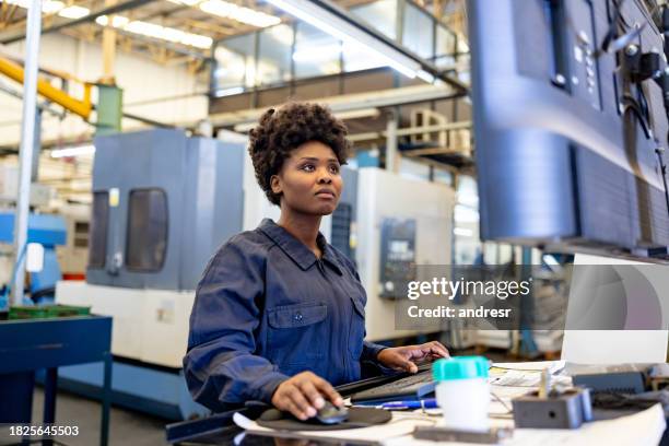 female employee operating a machine at a manufacturing factory - spindle stock pictures, royalty-free photos & images