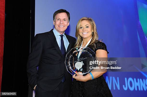 Bob Costas and Sports Legend and gymnast Shawn Johnson speak onstage at the 28th Annual Great Sports Legends Dinner to Benefit The Buoniconti Fund To...