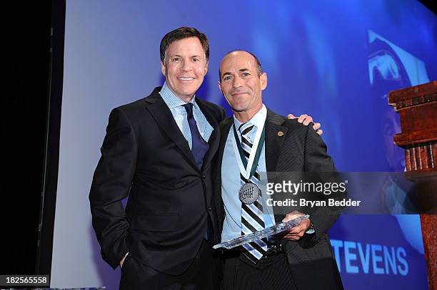 Personality Bob Costas and Sports Legend and jockey Gary Stevens pose with award at the 28th Annual Great Sports Legends Dinner to Benefit The...
