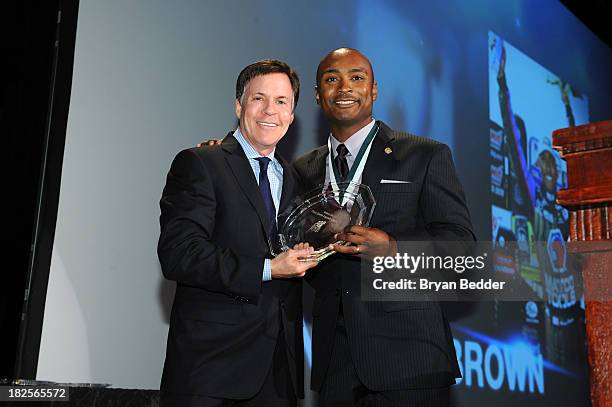 Personality Bob Costas and Sports Legend and Drag Racecar driver Antron Brown pose with award at the 28th Annual Great Sports Legends Dinner to...