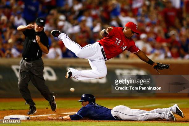 Sam Fuld of the Tampa Bay Rays steals third base against Adrian Beltre of the Texas Rangers in the ninth inning during the American League Wild Card...