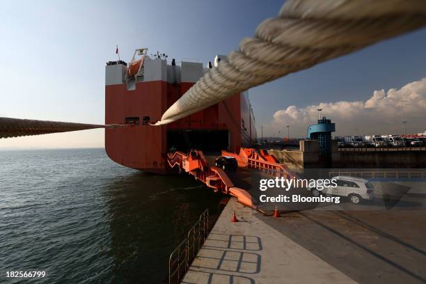 Kia Motors Corp. Vehicles bound for export are driven into a Wallenius Lines AB roll-on/roll-off cargo ship at the port of Pyeongtaek in Pyeongtaek,...