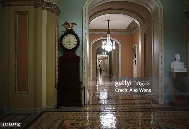 The Ohio Clock which shows the time has just passed midnight stands on the Senate side of the U.S. Capitol October 1, 2013 on Capitol Hill in...