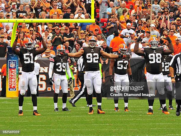 Linebacker Barkevious Mingo, defensive end Desmond Bryant, and defensive tackle Phil Taylor of the Cleveland Browns try to get the crowd louder...