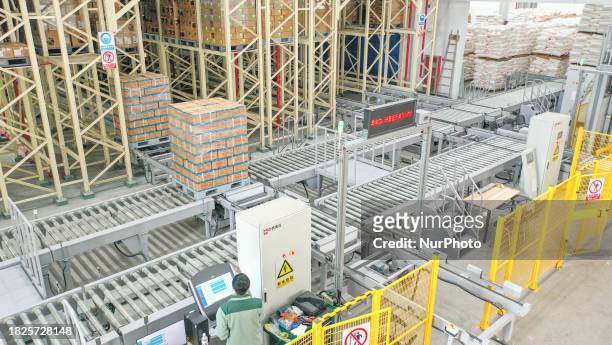 Goods are moving automatically on a tall shelf in an automated warehouse of a food company in Huzhou, Zhejiang Province, China, on December 6, 2023....