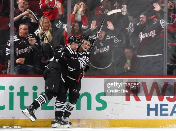 Timo Meier and Jack Hughes of the New Jersey Devils celebrate after Hughes scored a goal during the third period against the San Jose Sharks at...