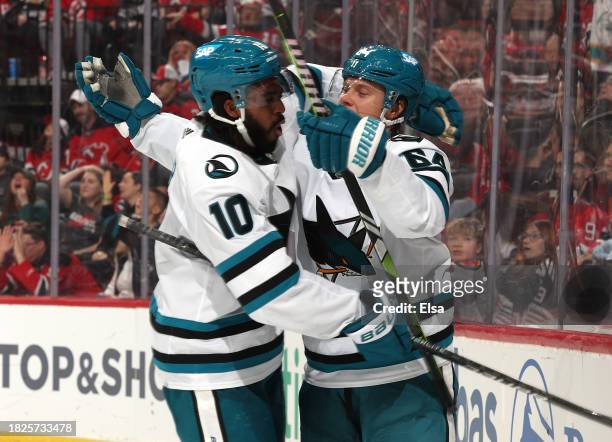 Anthony Duclair celebrates with teammate Mikael Granlund of the San Jose Sharks after Granlund scored during the third period against the New Jersey...