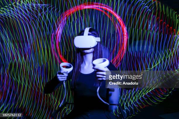 In this photo illustration, a woman experiences the Virtual Reality Headset in Ankara, Turkiye on December 02, 2023.