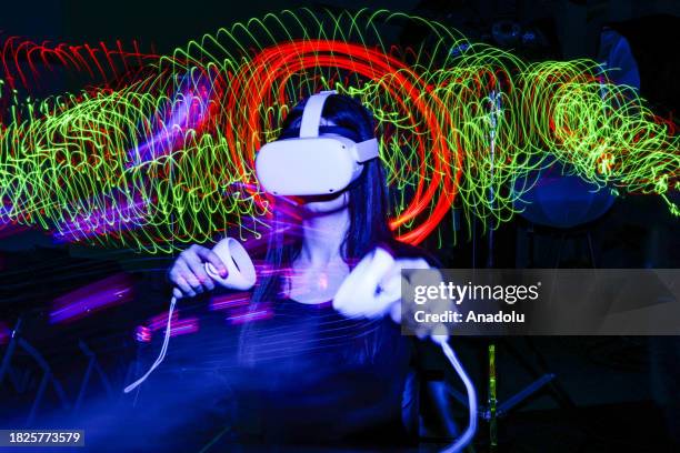 In this photo illustration, a woman experiences the Virtual Reality Headset in Ankara, Turkiye on December 02, 2023.