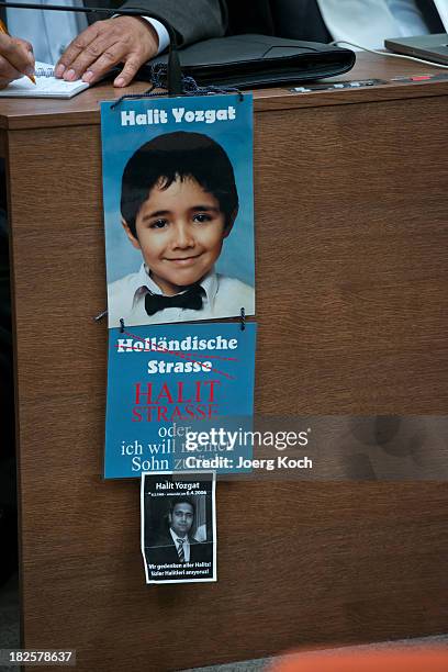 Ismail Yozgat, father of 2006 murdered Halit Yozgat, has put posters in front of his table and prepares for the beginning of today's NSU neo-Nazi...
