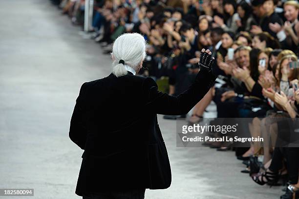Fashion designer Karl Lagerfeld acknowledges applause following the Chanel show as part of the Paris Fashion Week Womenswear Spring/Summer 2014 at...