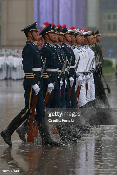 An honor guard practice before a ceremony marking the 64th anniversary of the founding of the People's Republic of China at Tiananmen Square on...