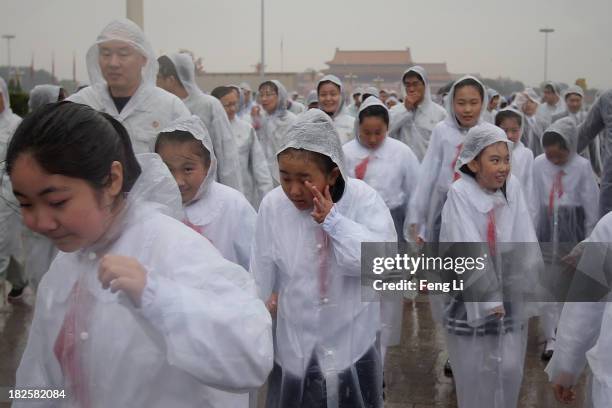 Chinese students leave Tiananmen Square after a ceremony marking the 64th anniversary of the founding of the People's Republic of China at Tiananmen...