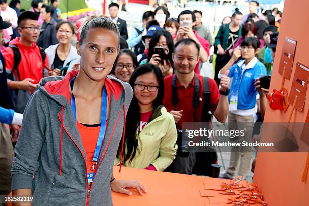 Polona Hercog of Slovenia visits the Jetstar booth during day four of the 2013 China Open at the National Tennis Center on October 1, 2013 in...