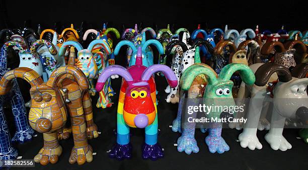 Some of the giant Gromit sculptures that have been decorated by artists & celebrities, are seen as they wait in a secret location, before being...