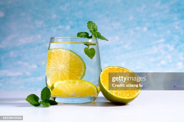 a glass of water with oranges and mint - soda lime mint stock pictures, royalty-free photos & images