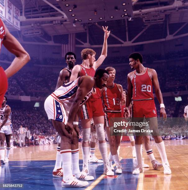 George McGinnis and Caldwell Jones of the Philadelphia 76ers and Bill Walton,Dave Twardzik and Maurice Lucas of the Portland Trailblazers in action...