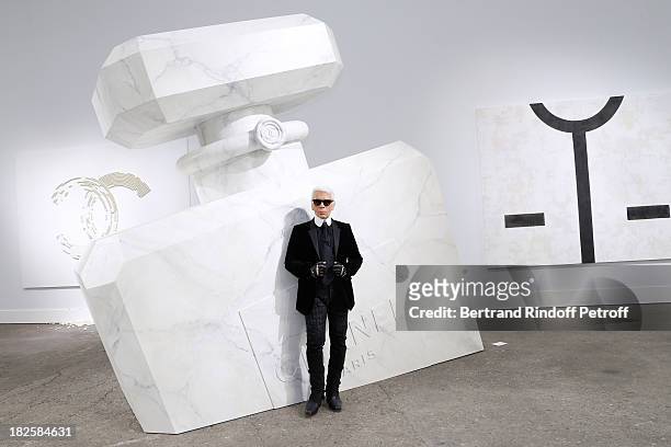 Fashion designer Karl Lagerfeld poses in front of his works before the Chanel show as part of the Paris Fashion Week Womenswear Spring/Summer 2014,...