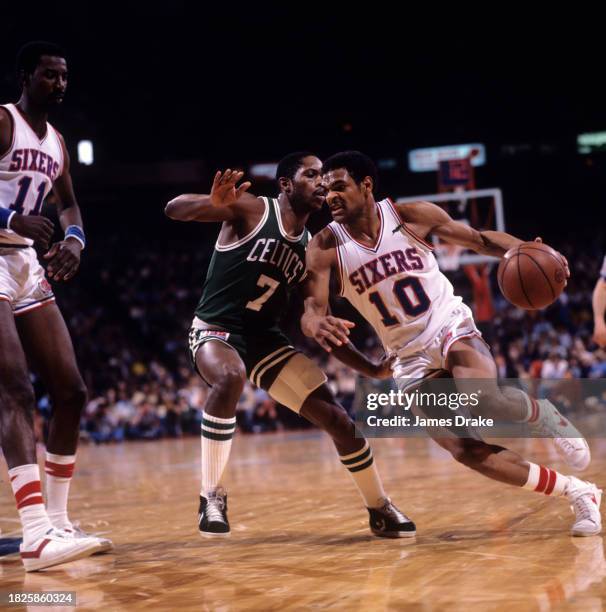 Maurice Cheeks of the Philadelphia 76ers drives against Nate 'Tiny' Archibald of the Boston Celtics during Game Three of the Eastern Conference...