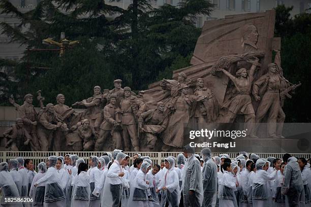 Chinese students leave Tiananmen Square after a ceremony marking the 64th anniversary of the founding of the People's Republic of China at Tiananmen...