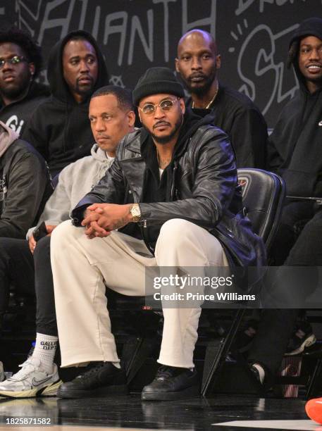 Carmelo Anthony Sits Court side during Overtime Elite Arena Opening Night at Overtime Elite Arena on December 1, 2023 in Atlanta, Georgia.