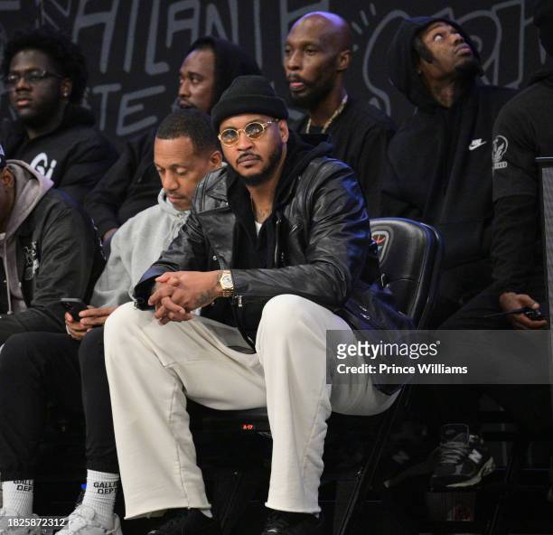 Carmelo Anthony Sits Court side during Overtime Elite Arena Opening Night at Overtime Elite Arena on December 1, 2023 in Atlanta, Georgia.
