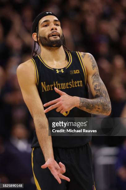 Boo Buie of the Northwestern Wildcats celebrates a three pointer against the Purdue Boilermakers during the second half at Welsh-Ryan Arena on...