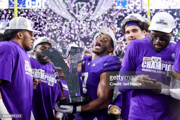 Dillon Johnson of the Washington Huskies yells while holding the Pac-12 Championship trophy after his team's win 34-31 against the Oregon Ducks...