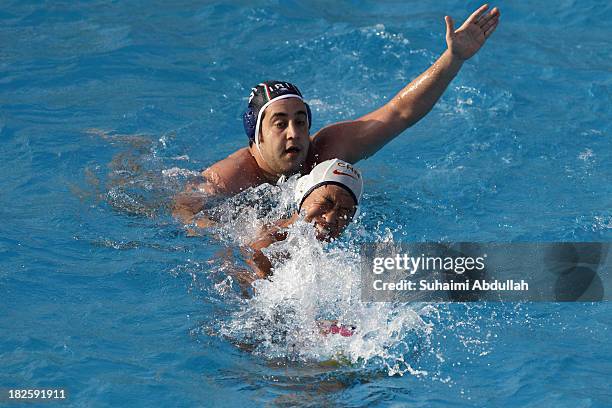 Xie Ze Kai of China and Ali Pirozkhah of Iran battle for the ball during the Asian Water Polo Cup between China and Iran at Toa Payoh Swimming...