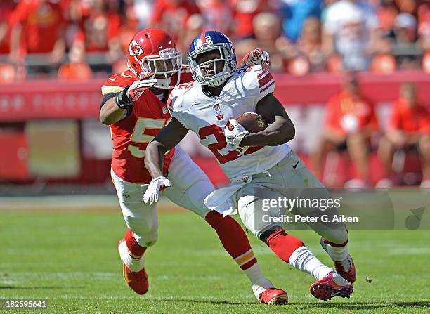 Running back David Wilson of the New York Giants rushes up field against linebacker Derrick Johnson of the Kansas City Chiefs during the second half...