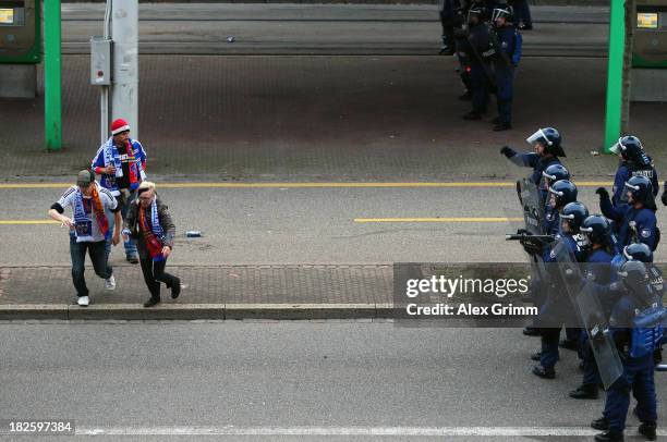 Police in riot gear seperate the fans prior to the UEFA Champions League Group E match between FC Basel 1893 and FC Schalke 04 outside St. Jakob-Park...