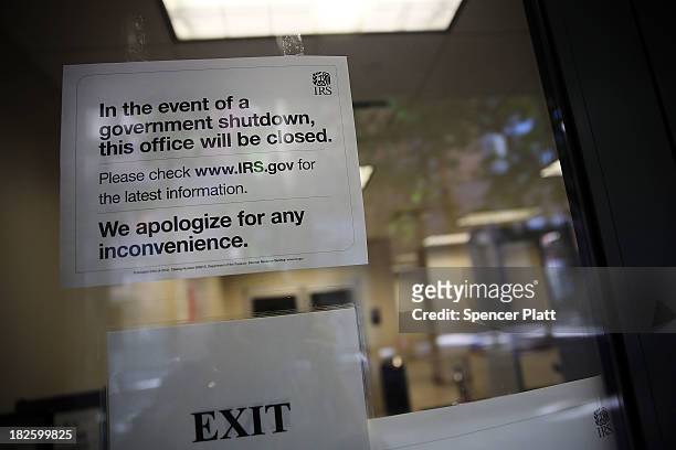 Sign is posted in the window of an IRS office in Brooklyn notifying that the office is closed due to the government shutdown on October 1, 2013 in...