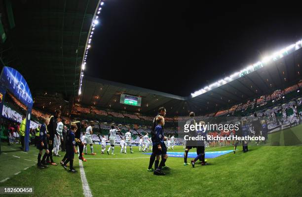 Celtic and Barcelona players lead out prior to the UEFA Champions League Group H match between Celtic and FC Barcelona at Celtic Park Stadium on...