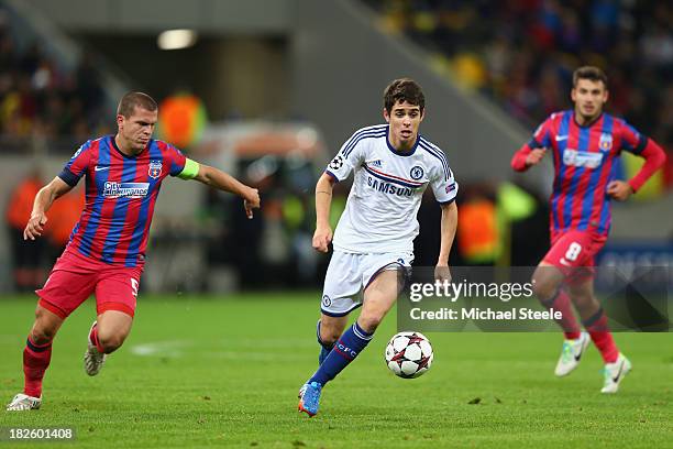 Oscar of Chelsea is tracked by Alexandru Bourceanu of Steaua Bucurestiduring the UEFA Champions League Group E Match between FC Steaua Bucuresti and...